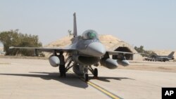 FILE - U.S.- made F-16 fighter jets stand on the tarmac upon their arrival to Balad air base, 75 kilometers (45 miles) north of Baghdad, Iraq.