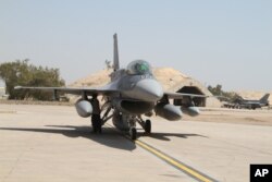 FILE - U.S.- made F-16 fighter jets stand on the tarmac upon their arrival to Balad air base, 75 kilometers (45 miles) north of Baghdad, Iraq.