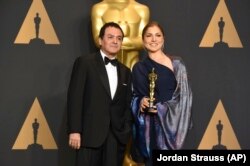 Firouz Naderi, left, and Anousheh Ansari pose in the press room at the Oscars on Sunday, Feb. 26, 2017, at the Dolby Theatre in Los Angeles. (Photo by Jordan Strauss/Invision/AP)