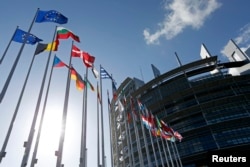 Flags of European Union member states fly in front of the European Parliament building in Strasbourg, France, April 15, 2014.