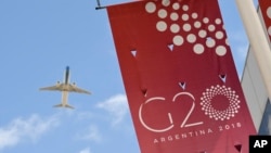 A jet liner flies over the G20 summit venue at the Costa Salguero Center in Buenos Aires, Argentina, Nov. 28, 2018.