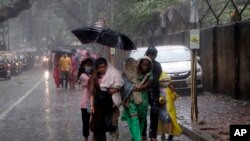 People of a slum relocate as a precautionary measure against cyclone in Mumbai, India, June 3, 2020.