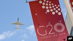 A jet liner flies over the G20 summit venue at the Costa Salguero Center in Buenos Aires, Argentina, Nov. 28, 2018.