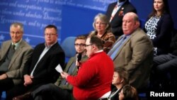 Ken Bone, a power plant employee from Belleville, Illinois stands to ask a question about energy policy and jobs to Republican U.S. presidential nominee Donald Trump and Democratic nominee Hillary Clinton during their presidential town hall debate at Wash