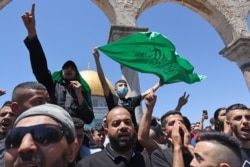 Palestinian Muslim worshippers chant slogans supporting the Islamist movement Hamas following Friday prayers in Jerusalem's al-Aqsa mosque compound, the third holiest site of Islam, May 14, 2021.
