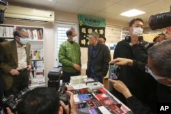 Lam Wing-kee, center right, is congratulated by Taiwan's Legislative Yuan Speaker Yu Shyi-kun, center left, on the opening day of his new book shop in Taipei, April 25, 2020.