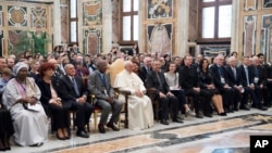 Pope Francis poses with the participants of a Catholic Church-backed international conference on fighting child pornography and protecting children in the digital age, at the Vatican, Oct. 6, 2017. 