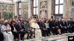 FILE - Pope Francis poses with the participants of a Catholic Church-backed international conference on fighting child pornography and protecting children in the digital age, at the Vatican, Oct. 6, 2017. 