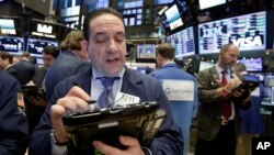 Trader Tommy Kalikas works on the floor of the New York Stock Exchange, Dec. 9, 2016. 