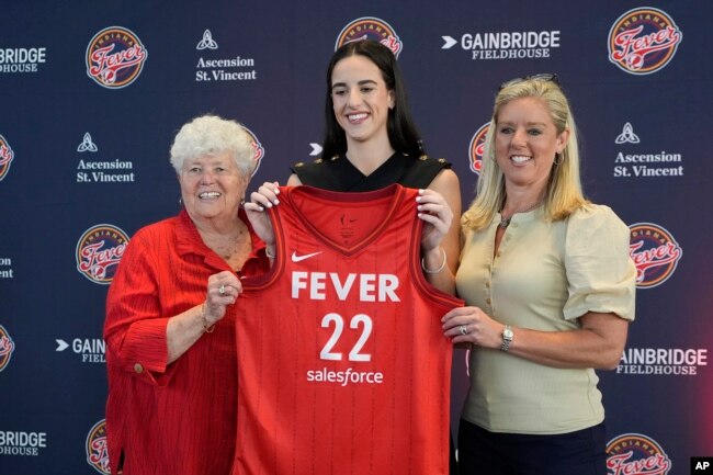 FILE - Indiana Fever's Caitlin Clark, middle, poses with general manager Lin Dunn, left, and head coach Christie Sides following a WNBA basketball news conference, Wednesday, April 17, 2024, in Indianapolis. (AP Photo/Darron Cummings)