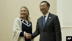 Menlu AS Hillary Rodham Clinton Kiri) dan Menlu Tiongkok Yang Jiechi berjabat tangan sebelum menghadiri pertemuan regioanal ASEAN di Phnom Penh (12/7).