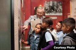 Mas Yamashita leads a school tour at the Japanese American National Museum where he volunteers every Friday. Yamashita, an American born in California, is one of the 120,000 people held in an internment camp during the WWII. (Courtesy: Japanese American N