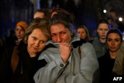 FILE —People mourn the death of Russian opposition leader Alexei Navalny at a makeshift memorial in front of the Russian Embassy in Warsaw on March 1, 2024.