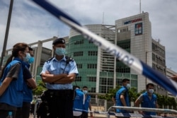 Police closed off the area outside the Next Media publishing offices as authorities conduct a search of the offices after the company's founder Jimmy Lai was arrested under the new national security law in Hong kong on August 10, 2020