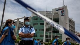Police closed off the area outside the Next Media publishing offices as authorities conduct a search of the offices after the company's founder Jimmy Lai was arrested under the new national security law in Hong kong on August 10, 2020