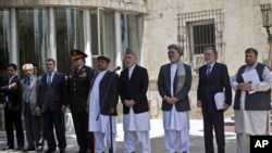 Afghan President Hamid Karzai (C), with his vice presidents and some key cabinet members, gives a speech regarding the U.S. plan to withdraw troops from Afghanistan, in Kabul June 23, 2011