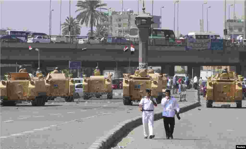 Egyptian army soldiers and armored personnel carriers deployed near Tahrir Square in Cairo, August 19, 2013. 