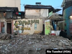 Mural memprotes rencana rumah deret dari pemerintah Kota Bandung nampak menghiasi sejumlah reruntuhan rumah warga RW 11 Tamansari. (Foto: Rio Tuasikal/VOA)