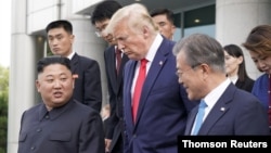 U.S. President Donald Trump, North Korean leader Kim Jong Un and South Korean President Moon Jae-in leave after a meeting at the demilitarized zone separating the two Koreas, in Panmunjom, South Korea, June 30, 2019. (Reuters)