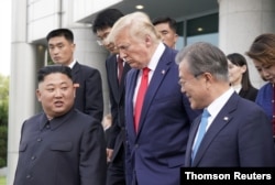 FILE - U.S. President Donald Trump, North Korean leader Kim Jong Un and South Korean President Moon Jae-in leave a meeting at the demilitarized zone separating the two Koreas, in Panmunjom, South Korea, June 30, 2019.