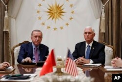FILE - Vice President Mike Pence meets with Turkish President Recep Tayyip Erdogan at the Presidential Palace in Ankara, Turkey, Oct. 17, 2019.