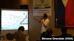 Mayor Eugenio Bito-onon of the Kalayaan Group of Islands, the Philippines-controlled outcroppings in the Spratly Islands, points out the Philippines' claims in the Spratlys during a fundraising dinner to gain support for a proposed "ecotourism zone" in the disputed Spratlys, in Makati City, Philippines, Aug. 23, 2015.