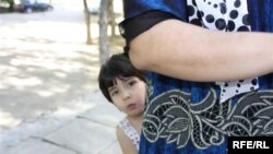 As many Tajik children lose both their parents to labor migration, this is placing an increasing burden on other family members left behind to look after them. (File Photo)