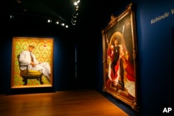 Paintings of LL Cool J, left, and Ice-T, both by Kehinde Wiley, are part of the exhibit "RECOGNIZE! Hip Hop and Contemporary Portraiture," at the National Portrait Gallery in Washington, Feb. 5, 2008.