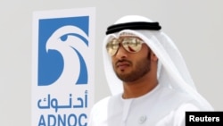 FILE - An Emirati man is seen near the logo of ADNOC in Ruwais, United Arab Emirates May 14, 2018. 