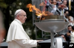 Pope Francis speaks next to a "reconciliation flame" during a ceremony at the presidential palace in Bogota, Colombia, Sept. 7, 2017.