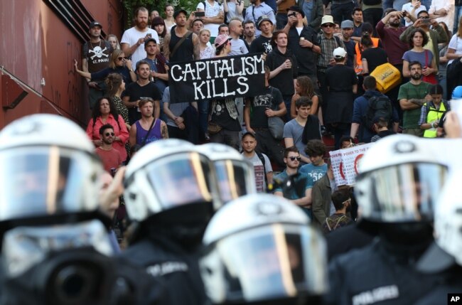 Police officers confront a protest against the upcoming G-20 summit in Hamburg, Germany, July 6, 2017.