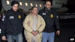 FILE - In this Jan. 19, 2017, file photo, provided by U.S. law enforcement, authorities escort Joaquin "El Chapo" Guzman, center, from a plane to a waiting caravan of SUVs at Long Island MacArthur Airport, in Ronkonkoma, N.Y. 