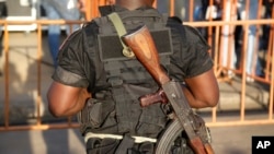 FILE - Ivory Coast troop provides security before the arrival of incumbent President Alassane Ouattara at his election rally in Abidjan, Ivory Coast. 