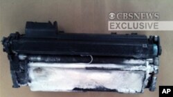 This image provided by CBS News shows a printer toner cartridge with wires and powder found in a package aboard a plane searched in East Midlands, north of London, 29 Oct 2010