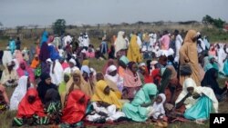 Muslims perform an Eid al-Fitr prayer in an outdoor open area in Lagos, Nigeria, May 13, 2021.