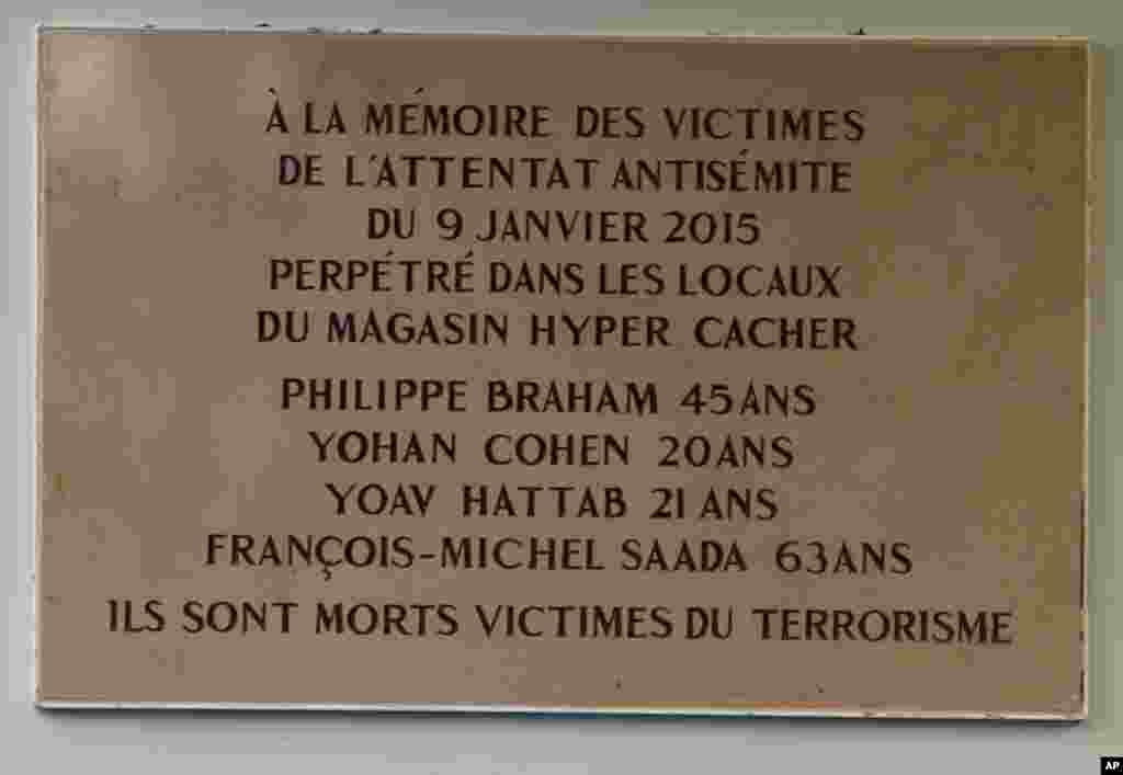 A plaque unveiled by President Francois Hollande pays tribute to the victims of last year's attacks outside a kosher supermarket. 