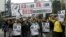 FILE - Demonstrators hold up portraits of five missing staff members of a publishing house and a bookstore during a protest over the disappearance of booksellers in Hong Kong, Jan. 10, 2016. 