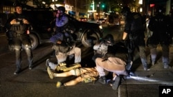 A man is being treated after being shot Saturday, Aug. 29, 2020, in Portland, Ore. Fights broke out in downtown Portland Saturday night as a large caravan of supporters of President Donald Trump drove through the city, clashing with counter…