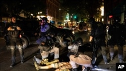 A man is being treated after being shot, Aug. 29, 2020, in Portland, Ore. 