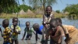 FILE - Children wash in muddy floodwaters in Wang Chot, Old Fangak County, Jonglei state, South Sudan, Nov. 26, 2020. 