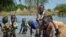 FILE - Children wash in muddy floodwaters in Wang Chot, Old Fangak County, Jonglei state, South Sudan, Nov. 26, 2020. 