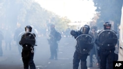 FILE - Police clear demonstrators from Lafayette Park near the White House in Washington, June 1, 2020, as they protest the death of African American George Floyd. Floyd died after being restrained by Minneapolis police officers.