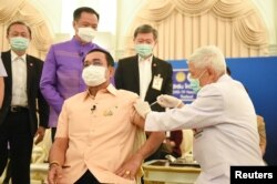 Thailand's Prime Minister Prayuth Chan-ocha receives an injection of the AstraZeneca coronavirus disease (COVID-19) vaccine at the Government House in Bangkok, Thailand, March 16, 2021.