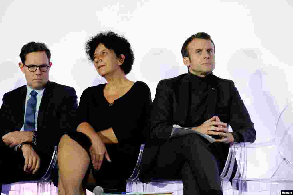 French President Emmanuel Macron, right, and French Minister of Higher Education, Research and Innovation Frederique Vidal, center, attend the ceremony marking the 80th anniversary of the French National Centre for Scientific Research (CNRS) at the Palais de la Decouverte in Paris, Nov. 26, 2019.