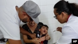 A boy cries as he receives a vaccine against yellow fever at a public health center in Sao Paulo, Brazil, Jan. 16, 2018. 