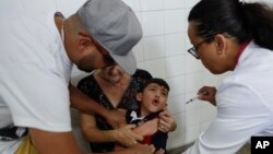 A boy cries as he receives a vaccine against yellow fever at a public health center in Sao Paulo, Brazil, Jan. 16, 2018. 