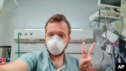 In this photo provided by Matt Swider, posted on Twitter on March 9, 2020, American tourist Matt Swider, takes a selfie while in quarantine in the north coast city of Marsa Matrouh, Egypt.