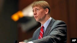 FILE - In this March 26, 2015, file photo, Consumer Financial Protection Bureau Director Richard Cordray speaks during a panel discussion in Richmond, Virginia. The Consumer Financial Protection Bureau has proposed a massive overhaul of the multibillion dollar debt-collection industry.