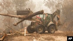 Funcionarios del Departamento de Defensa de Australia trabajan para combatir los incendios forestales en Bairnsdale el 6 de enero de 2020.