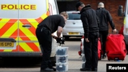 FILE - Inspectors from the Organization for the Prohibition of Chemical Weapons (OPCW) arrive to begin work at the scene of a nerve agent attack on former Russian agent Sergei Skripal, Salisbury, Britain, March 21, 2018. 